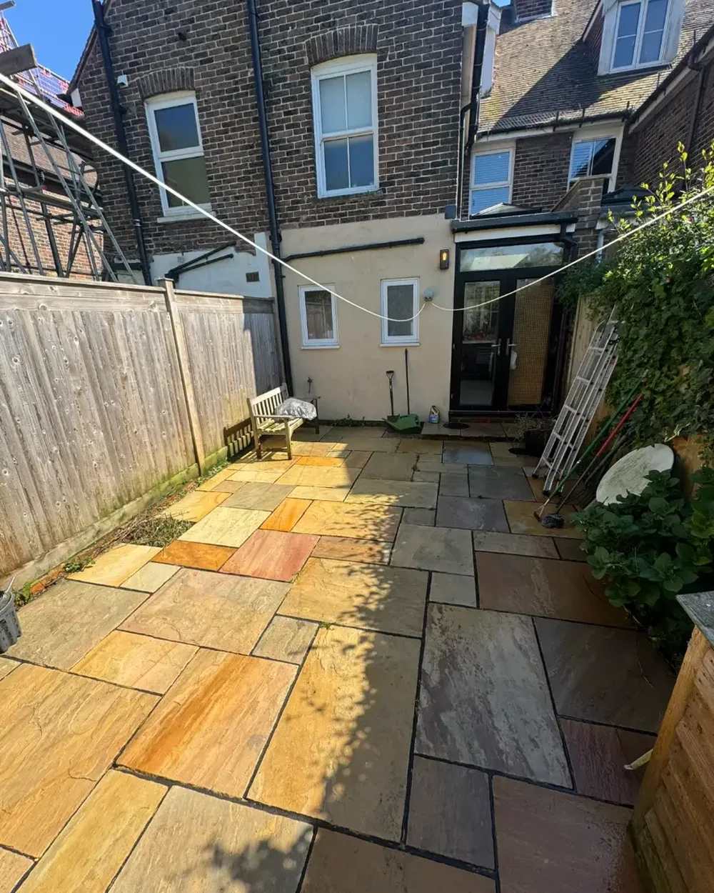 The same courtyard patio washed back to warm buff and grey sandstone