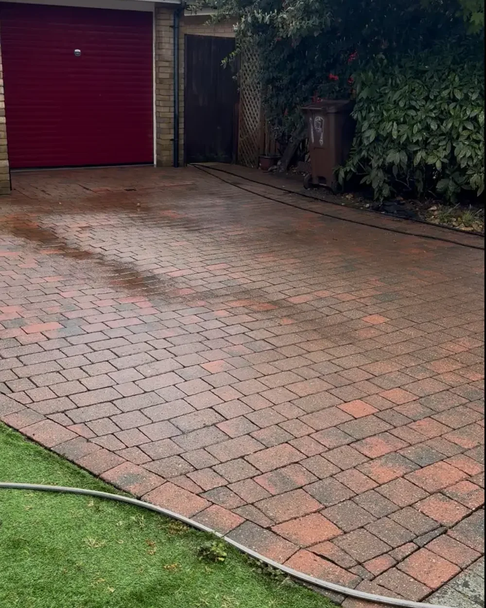 The same driveway cleaned back to a bright red and buff block finish